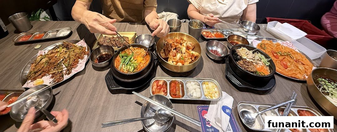 Diners enjoying a table full of delicious Korean dishes and banchan at Ajummas.