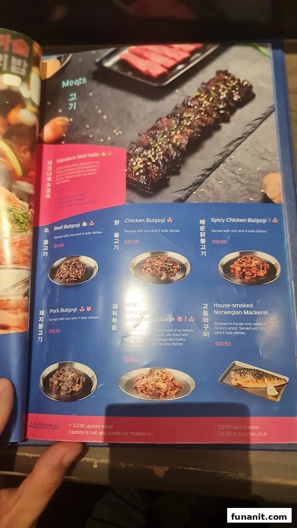 A close-up of a menu page from Ajummas, featuring various Korean meat dishes.