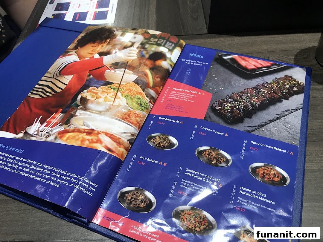 A blue menu displaying Korean meat dishes with prices and descriptions from Ajummas.