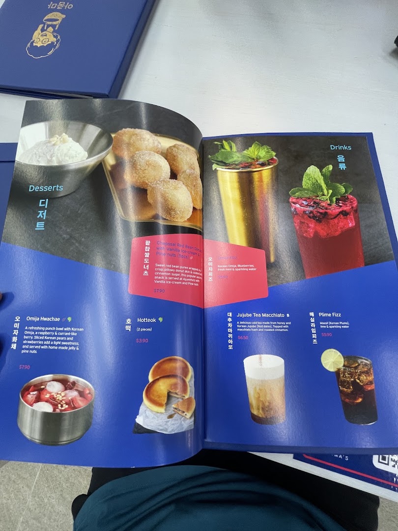 An open menu displaying desserts and drinks with images and descriptions.