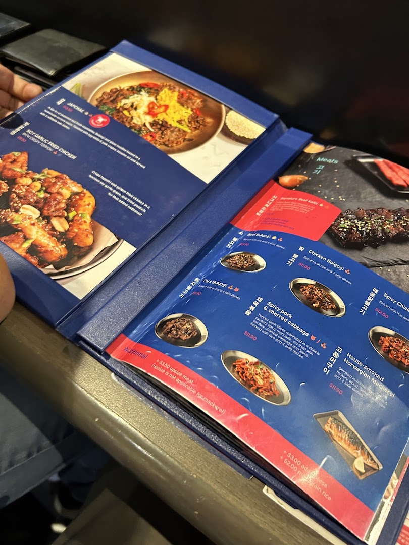 A close-up view of a Korean restaurant menu displaying various dishes and prices.