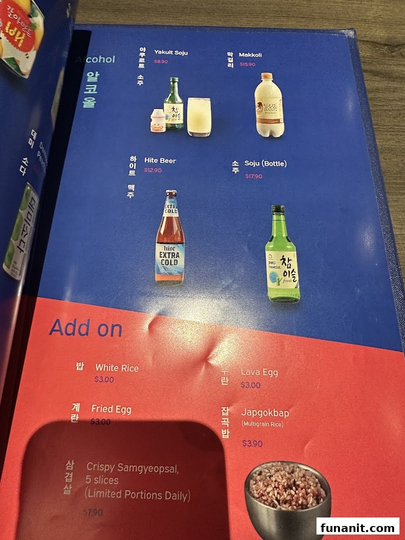 A close-up of Ajummas' menu displaying alcoholic beverages and various add-on dishes.
