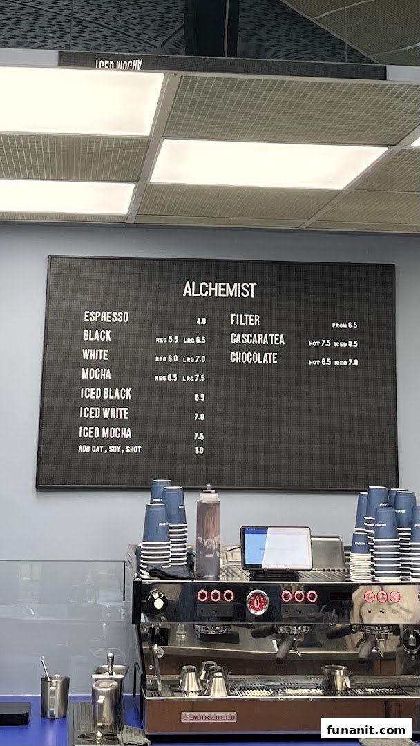 A clear view of Alchemist Funan's coffee menu board and espresso machine.