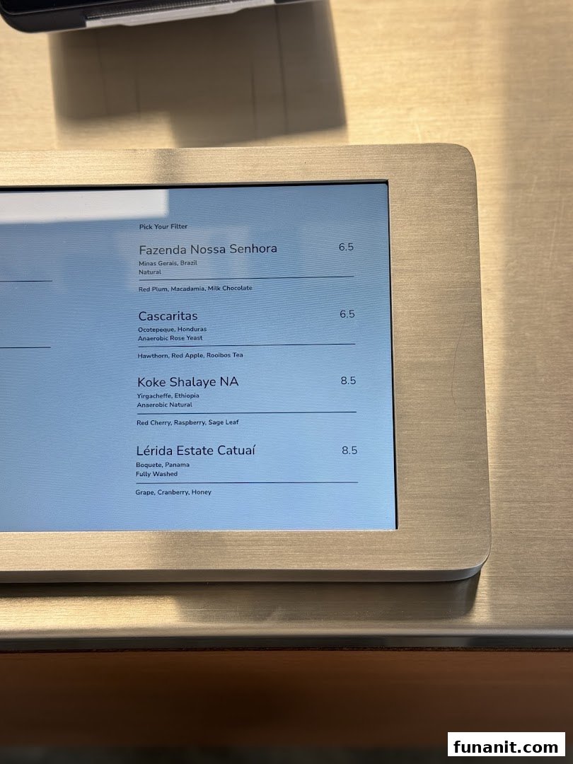A digital display showcasing a selection of specialty coffee and tea blends with prices.