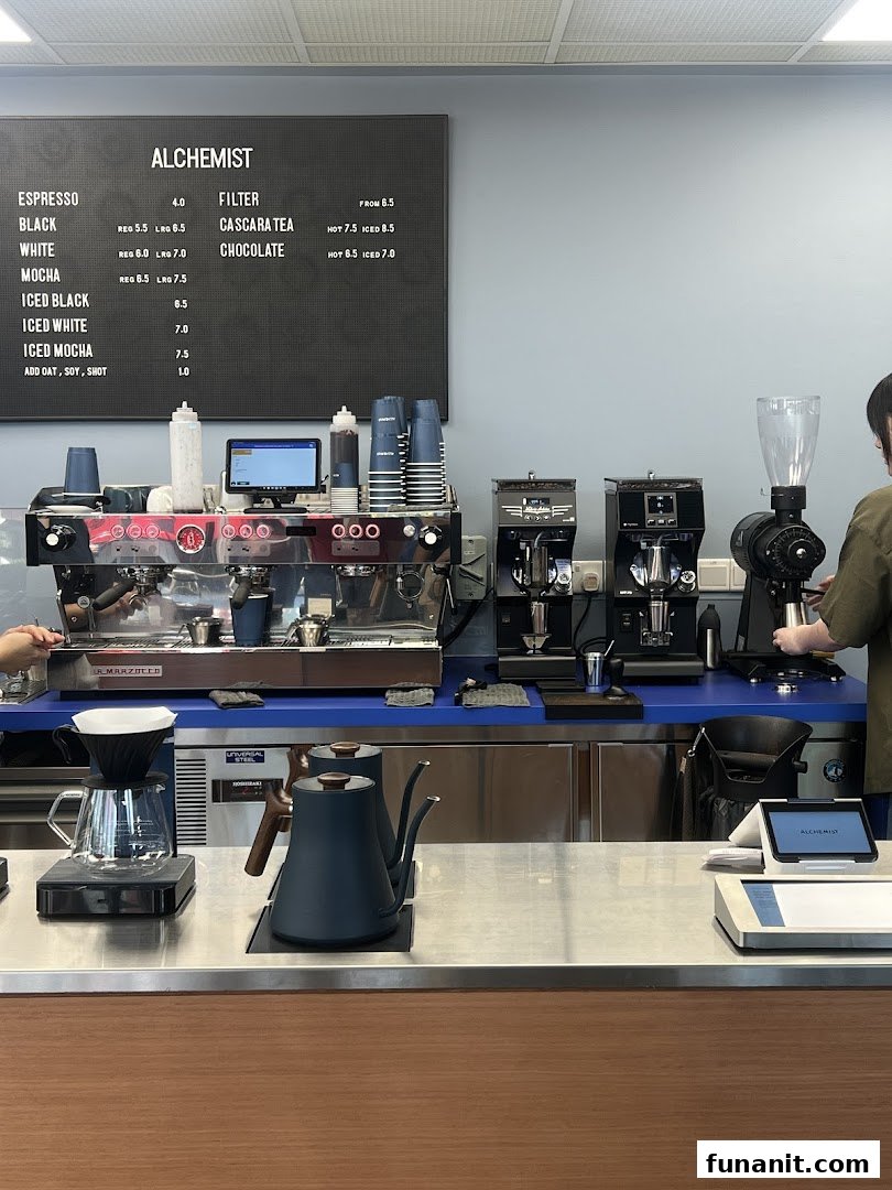 A modern coffee counter at Alchemist Funan, showcasing professional espresso machines and brewing equipment.