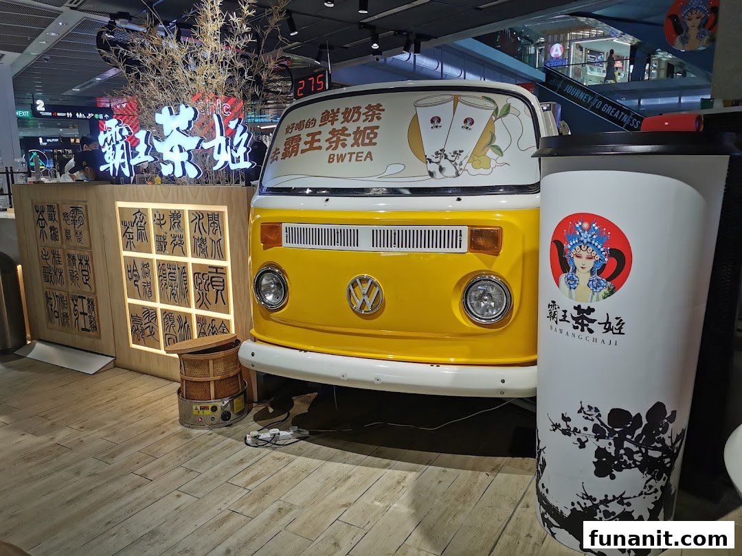 Vibrant interior of Bawangchaji tea shop featuring a yellow vintage van and traditional Chinese decor.