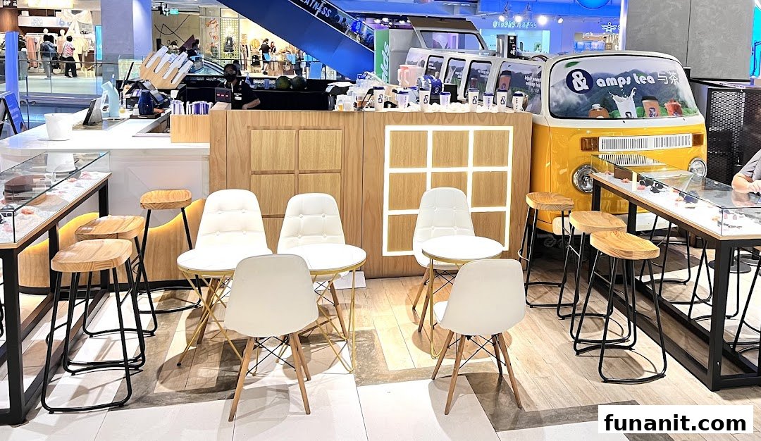 Interior view of amps tea, featuring a counter, modern seating, and a unique yellow van display.