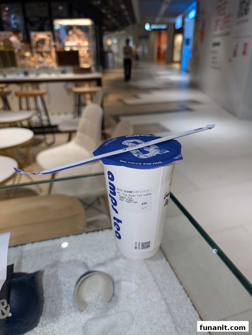 A refreshing bubble tea from Amps Tea, ready to enjoy in a modern shopping mall setting.