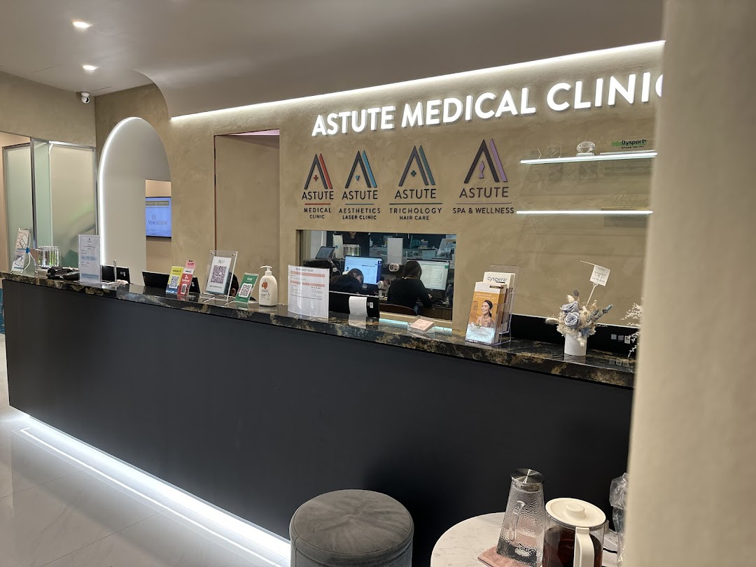 The modern reception area of Astute Medical Aesthetics Clinic, featuring a sleek desk and branding.