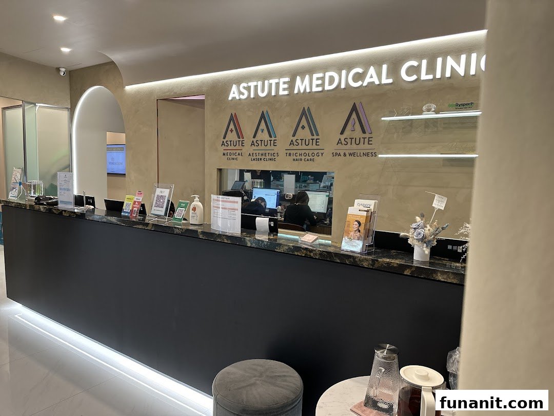 The modern reception area of Astute Medical Aesthetics Clinic, featuring a sleek desk and branding.