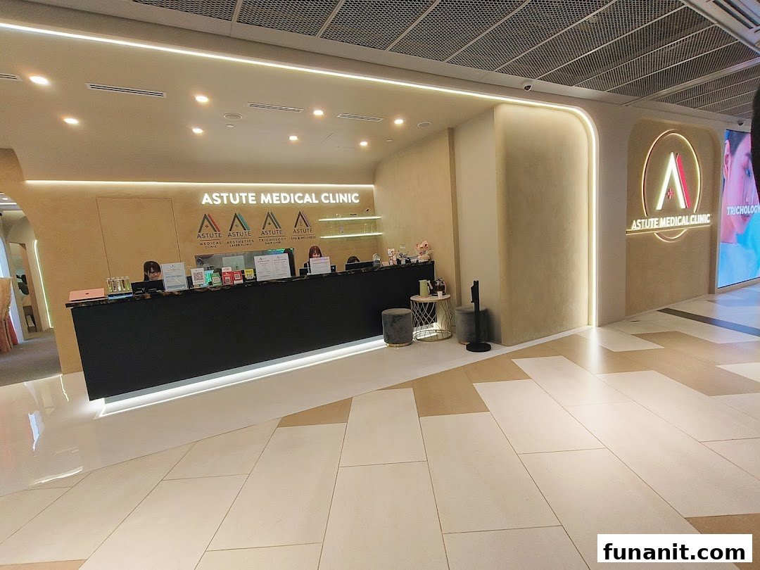 The modern and brightly lit reception area of Astute Medical Aesthetics Clinic with a long counter.