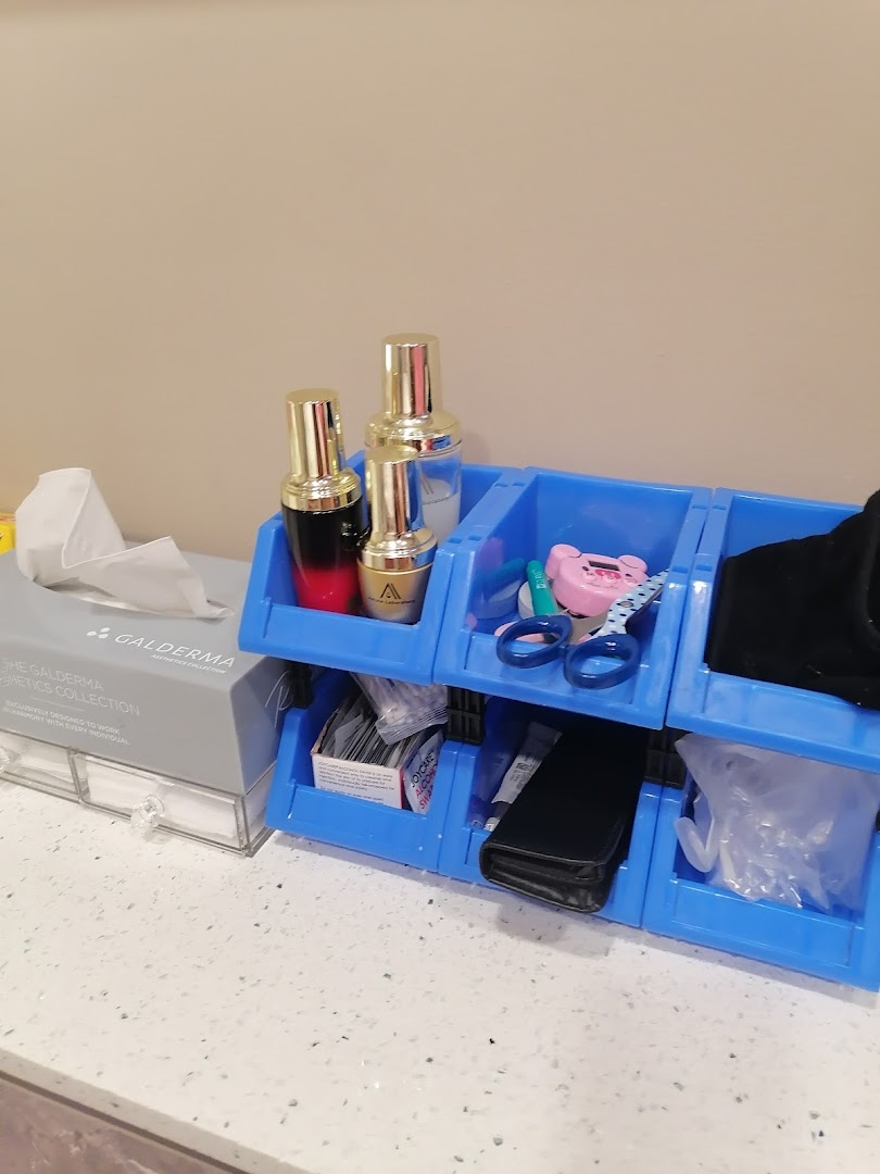 A countertop displaying medical aesthetics products, a tissue box, and an organizer with clinic supplies.
