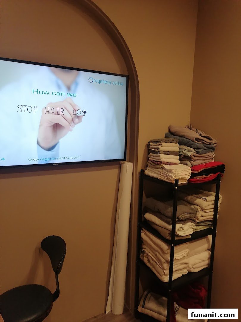 An interior shot of the clinic showing a TV screen displaying 'STOP HAIR LOSS' and a shelf with folded items.