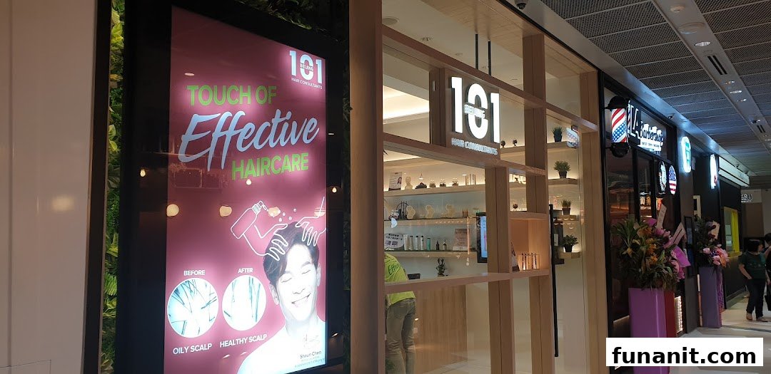 The brightly lit shop front of Beijing 101 Hair Consultants, featuring promotional signage.