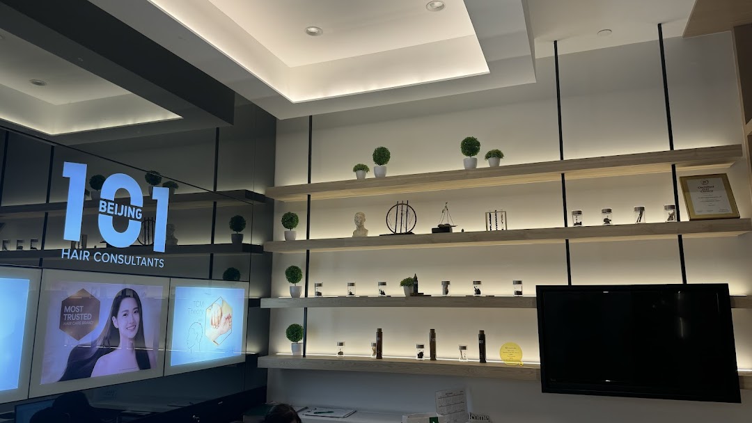 Interior view of Beijing 101 Hair Consultants, featuring branding, display shelves, and promotional screens.