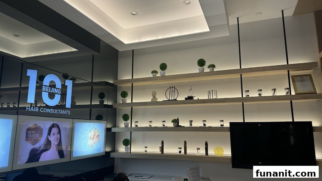 Interior view of Beijing 101 Hair Consultants, featuring branding, display shelves, and promotional screens.