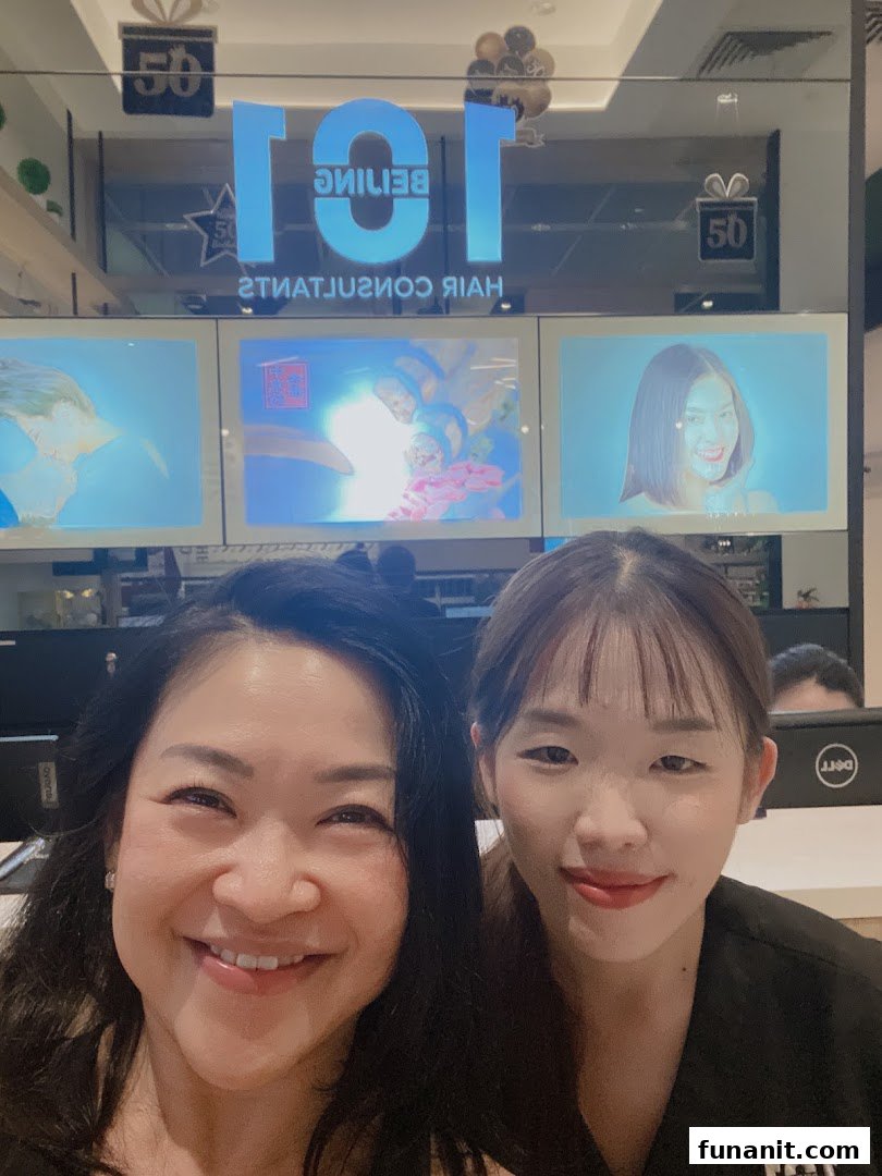 Two smiling women in front of Beijing 101 Hair Consultants, showcasing the shop's interior.