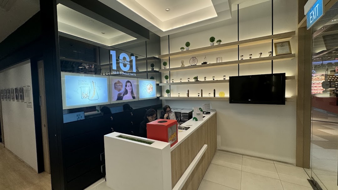 Interior view of Beijing 101 Hair Consultants reception area with staff, screens, and product displays.
