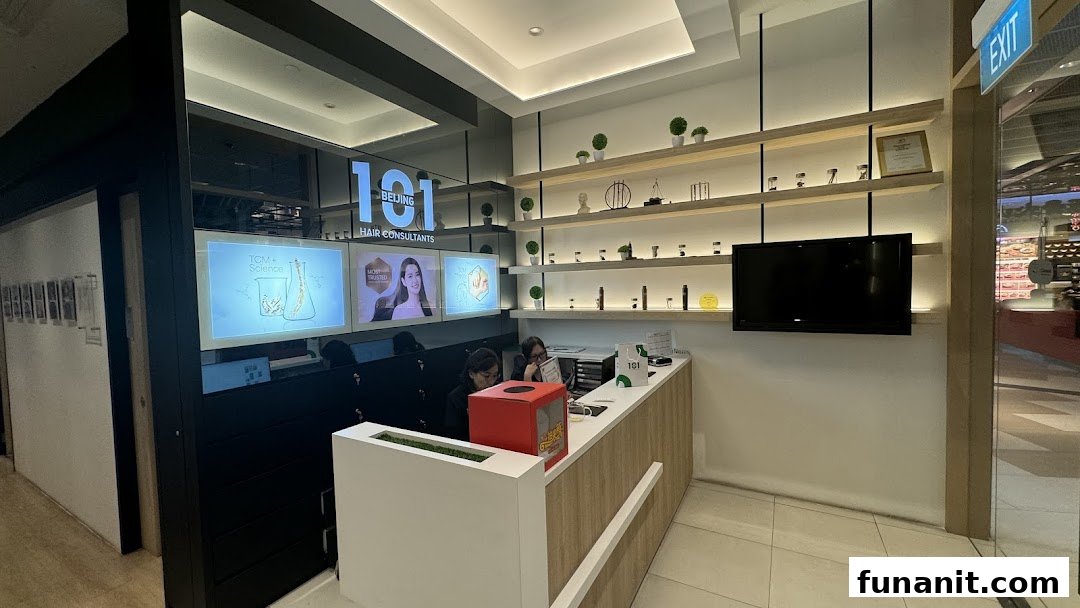 Interior view of Beijing 101 Hair Consultants reception area with staff, screens, and product displays.