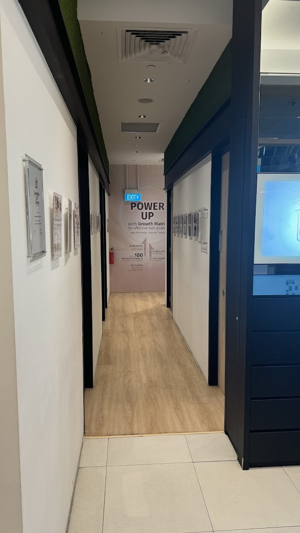 Interior hallway of Beijing 101 Hair Consultants, featuring promotional signage for hair growth treatments.