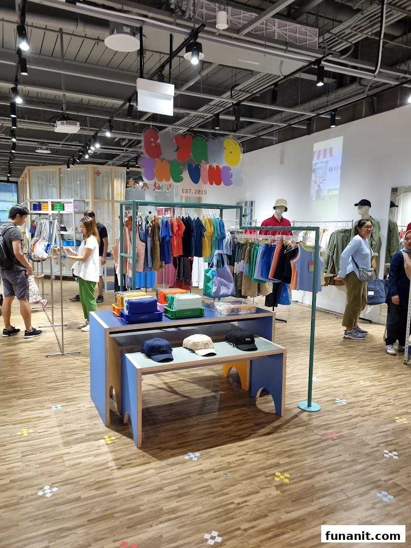 Vibrant interior of Beyond The Vines Design Store, featuring colorful apparel, accessories, and shoppers browsing.