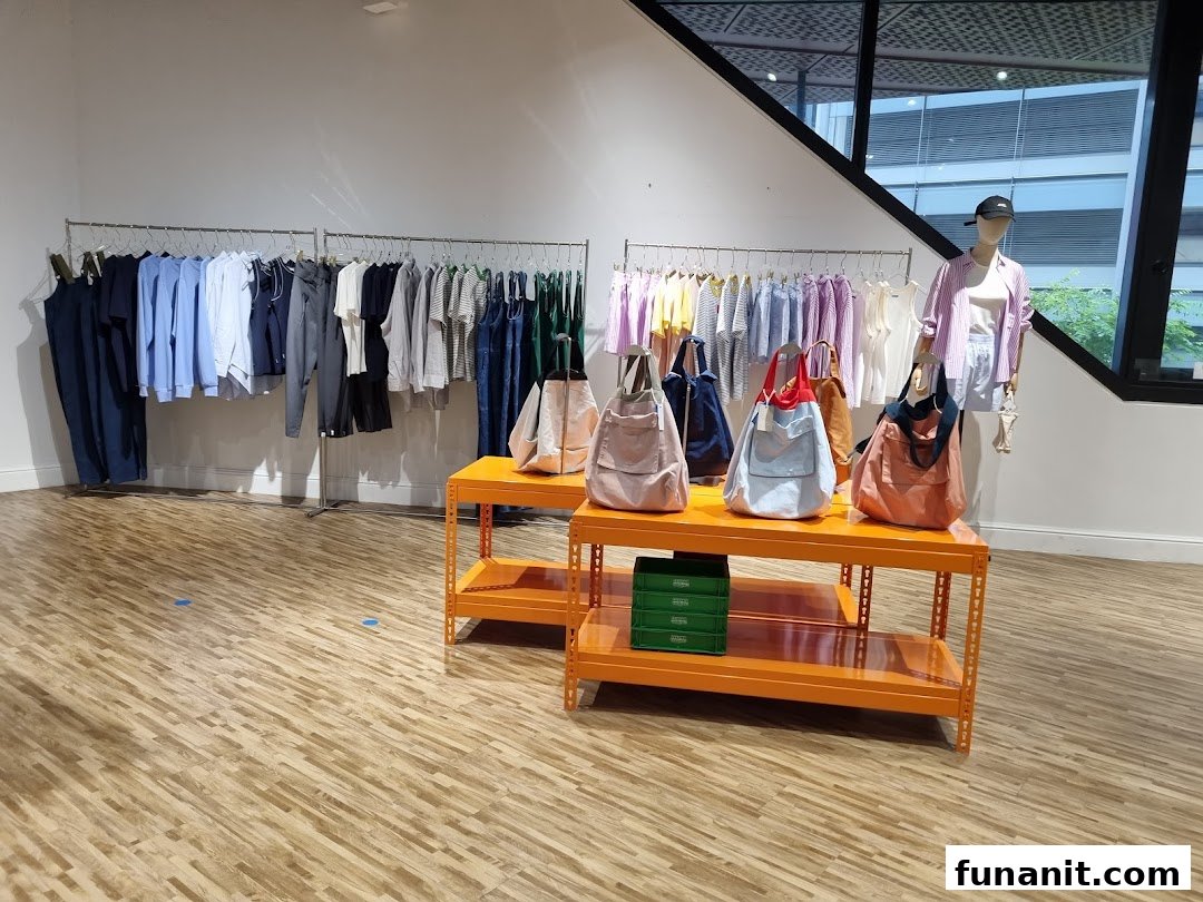 Interior view of Beyond The Vines Design Store, showcasing clothing racks, tote bags, and a mannequin.