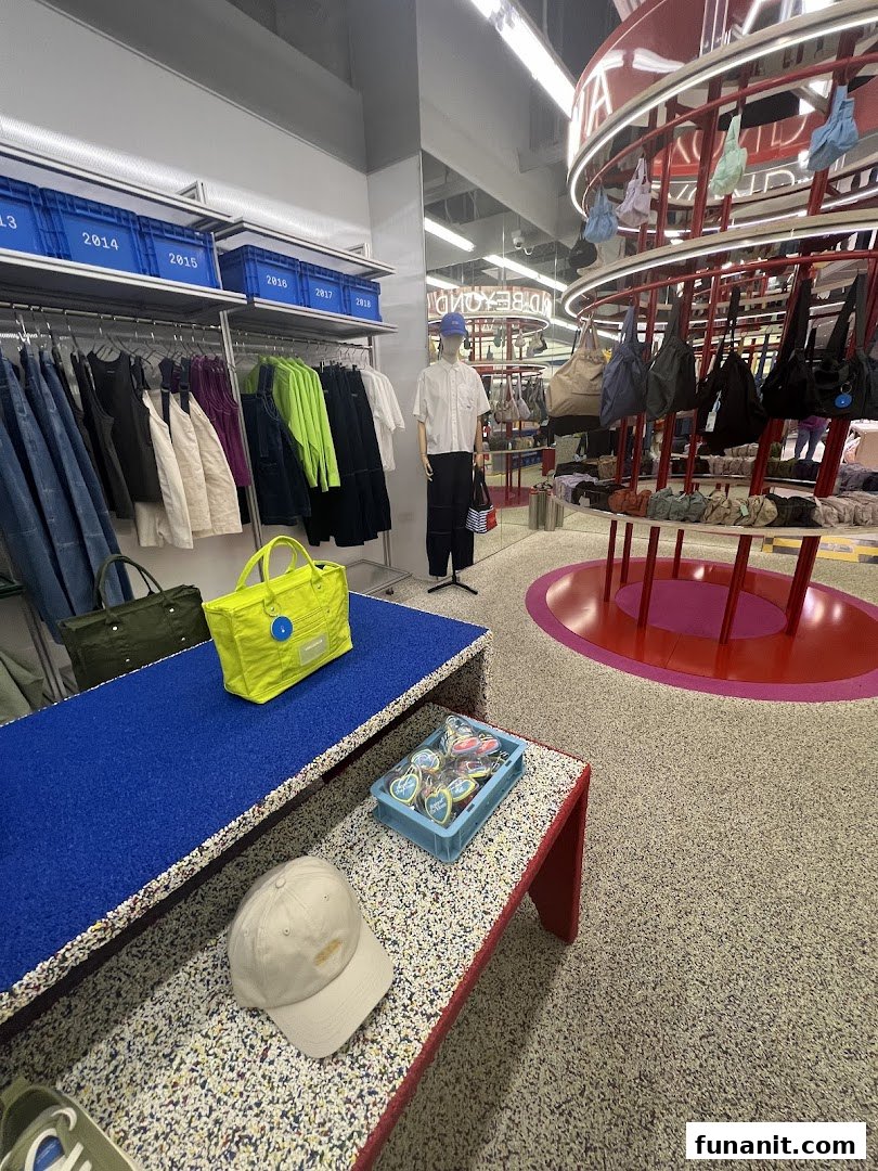 Interior view of Beyond The Vines Design Store, showcasing modern apparel, bags, and accessories on unique displays.