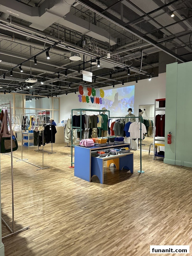 Interior view of Beyond The Vines Design Store, showcasing clothing, bags, and accessories on display.