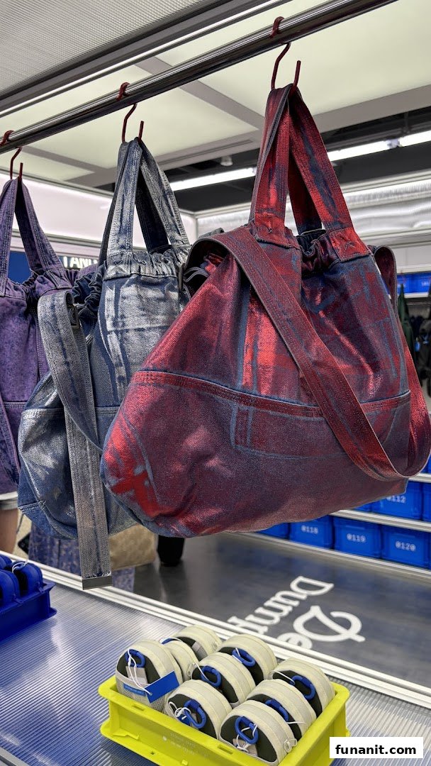 Colorful metallic-finish bags hang on display, with accessories in crates below, showcasing Beyond The Vines' unique designs.