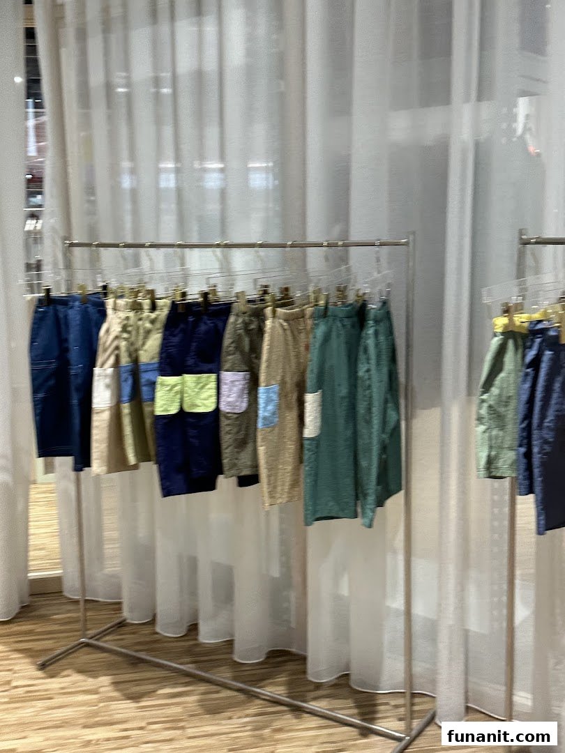 Colorful shorts and pants displayed on a clothing rack inside Beyond The Vines Design Store.