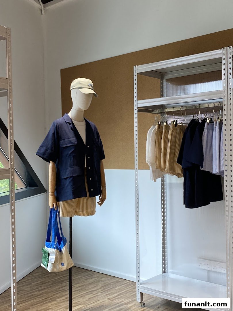 A mannequin displays apparel next to clothing racks inside Beyond The Vines Design Store.