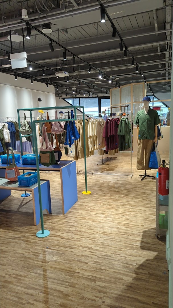 Interior view of Beyond The Vines Design Store, showcasing a wide range of apparel and accessories on display.