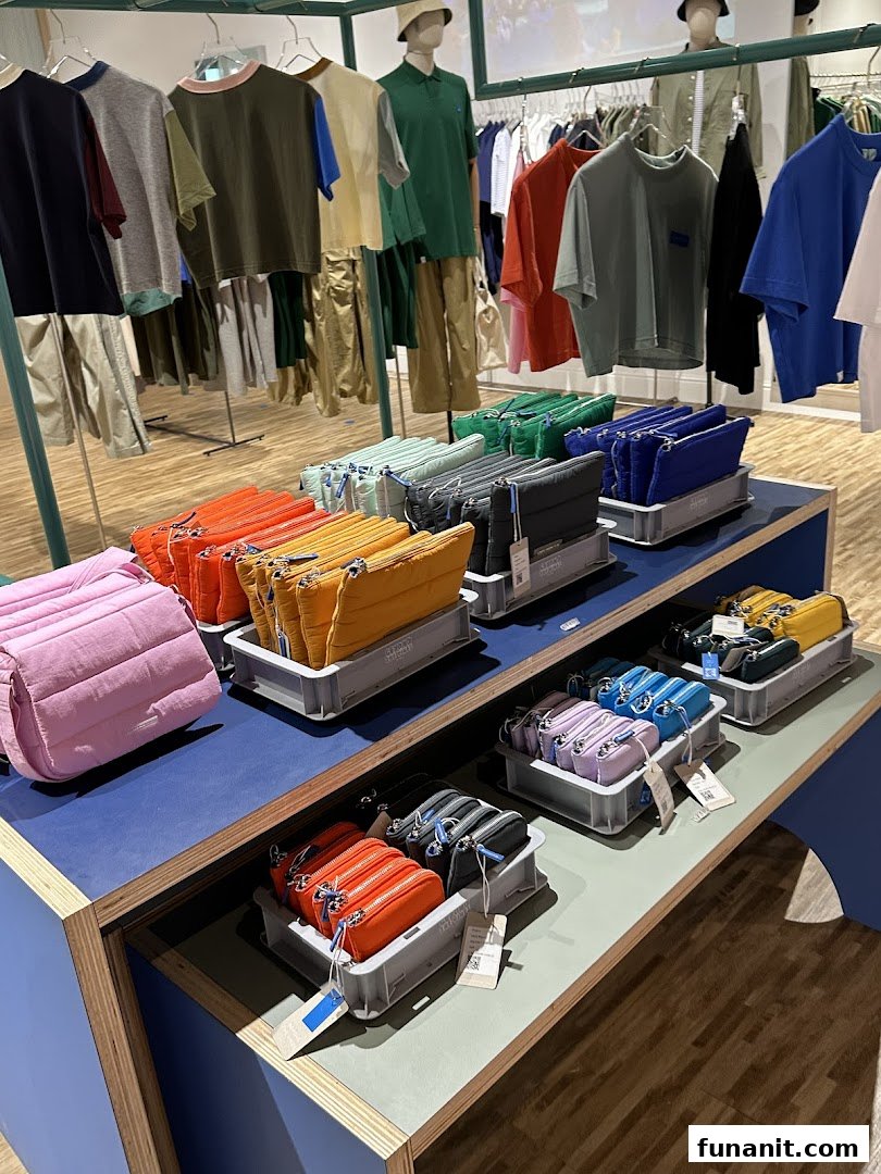Vibrant display of colorful bags and casual apparel in a modern retail store.