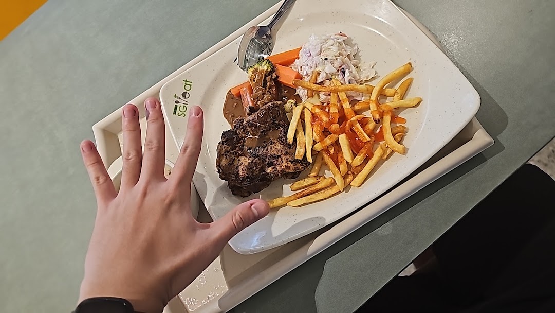 A hearty grilled chicken meal with fries and coleslaw, served on a white plate.