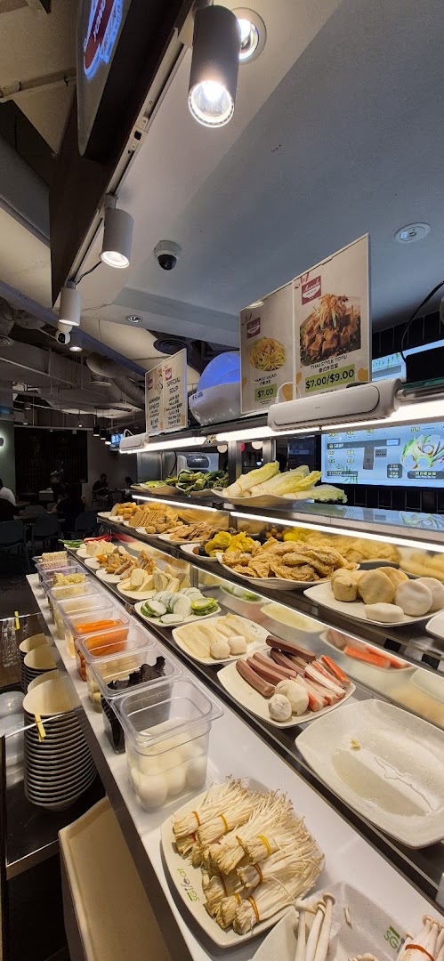 A vibrant display of fresh ingredients and prepared items on a food counter, ready for selection at Big Appetite.