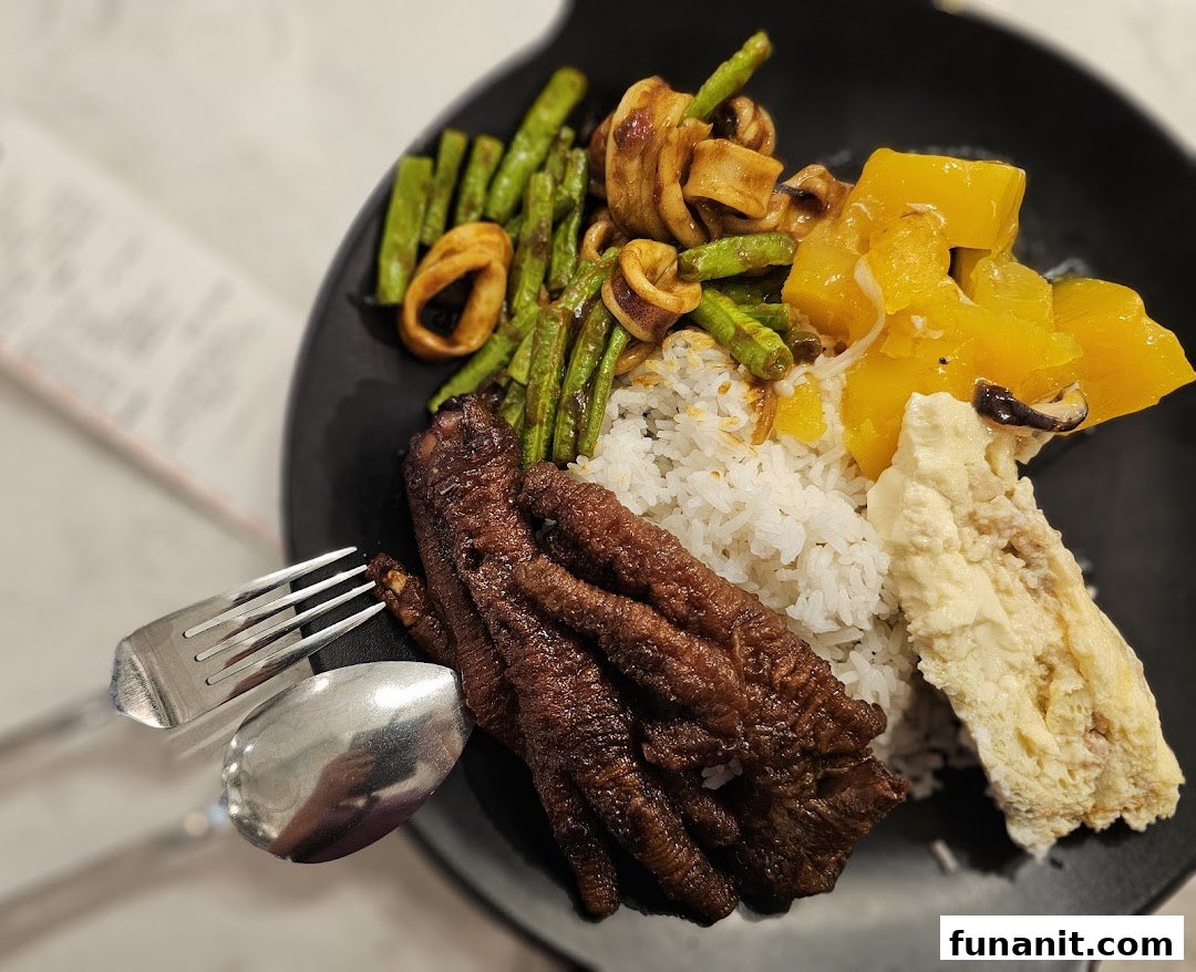 A close-up of a hearty meal featuring rice, chicken feet, squid, green beans, and pumpkin.