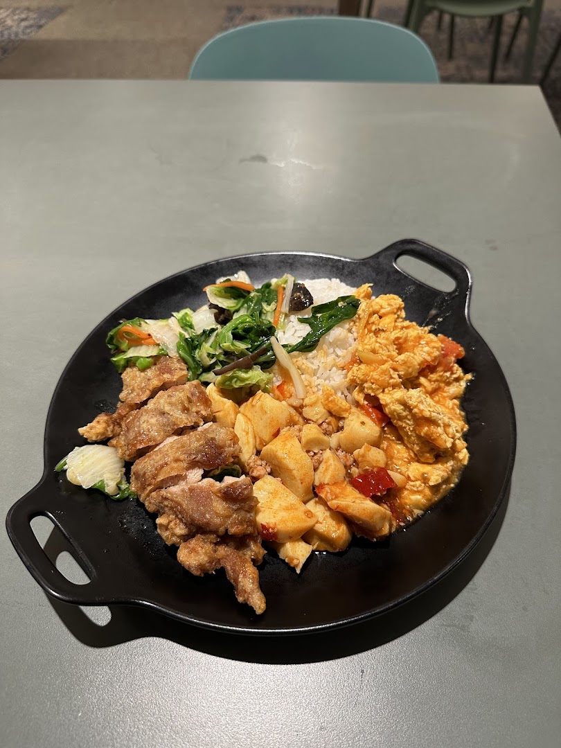 A hearty meal plate featuring fried chicken, rice, vegetables, and other savory dishes from Big Appetite.