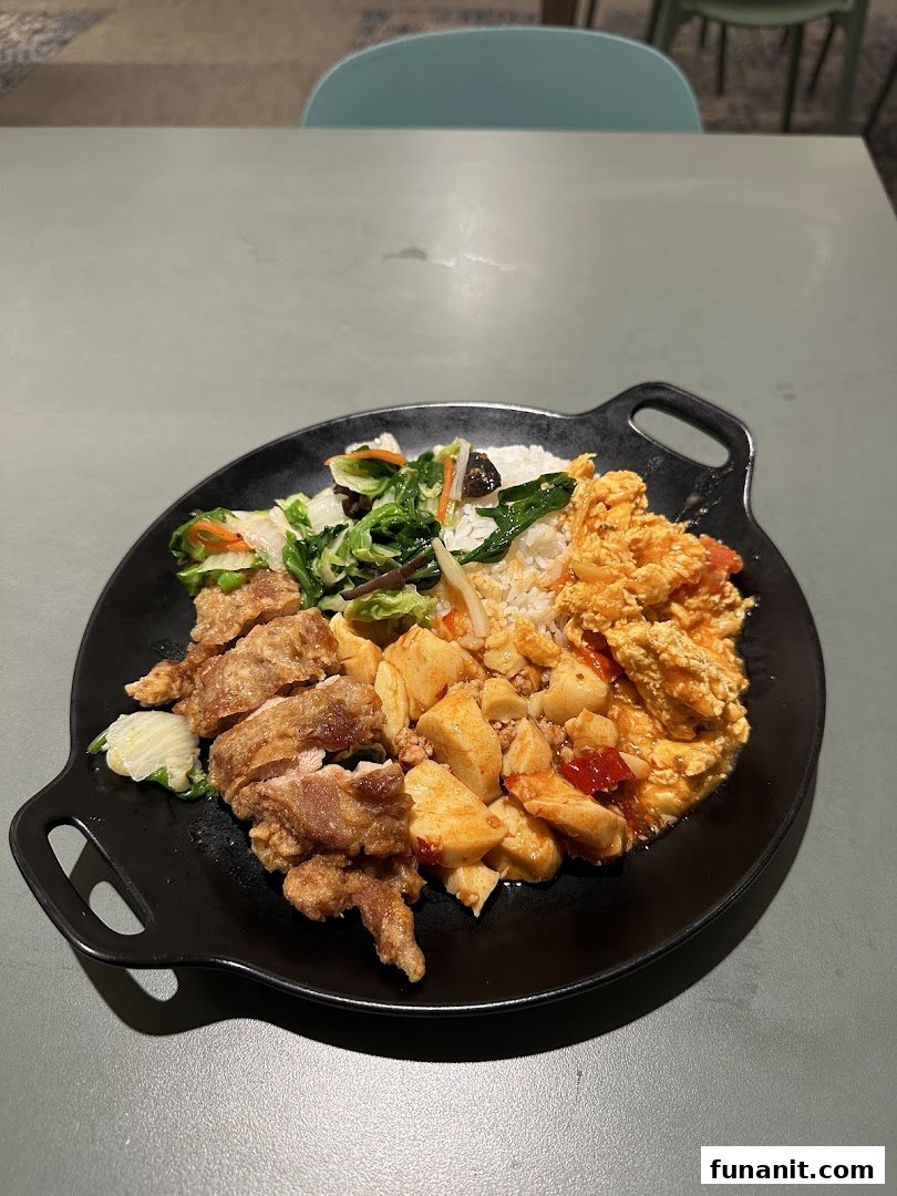 A hearty meal plate featuring fried chicken, rice, vegetables, and other savory dishes from Big Appetite.