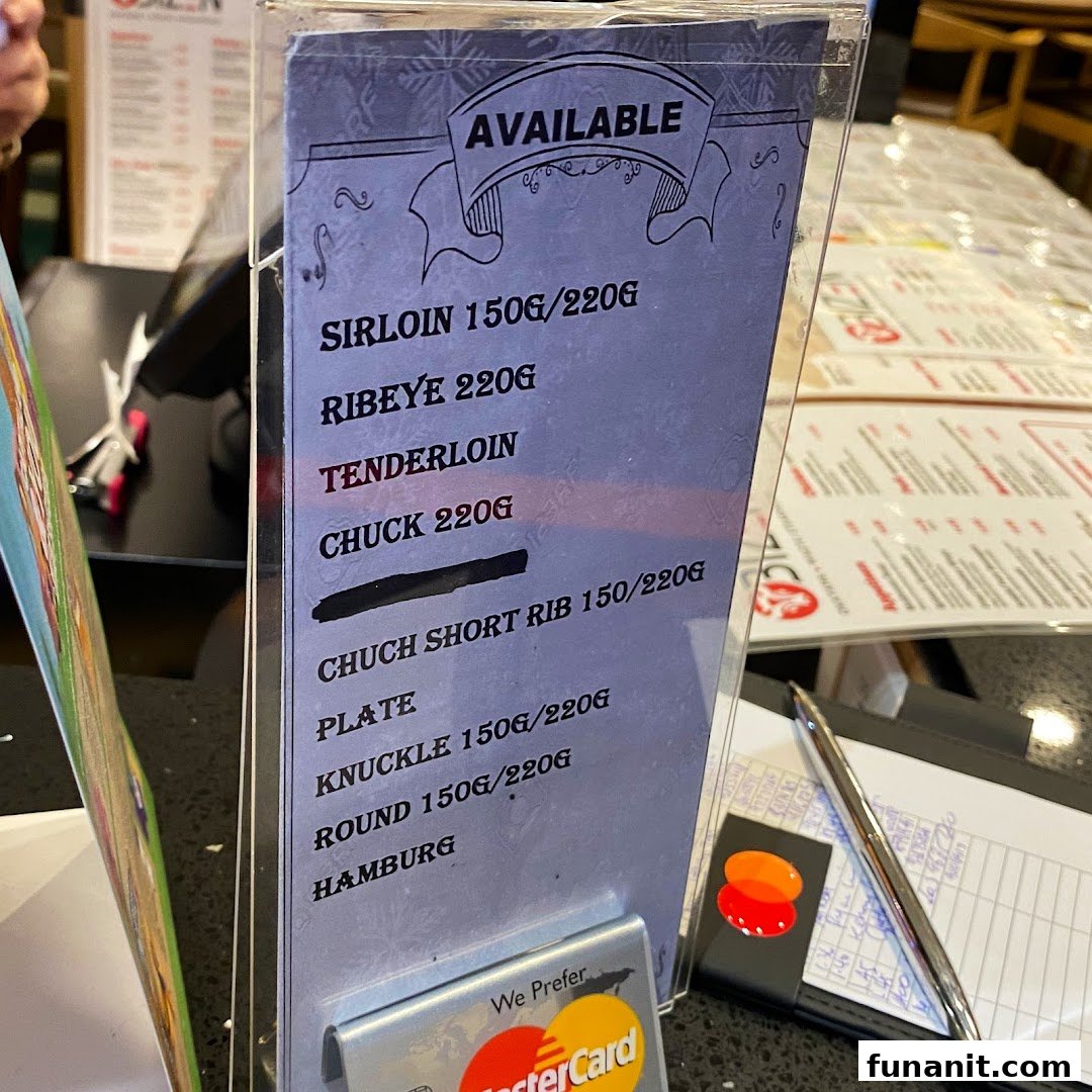 A close-up of a table-top menu displaying available wagyu steak cuts.