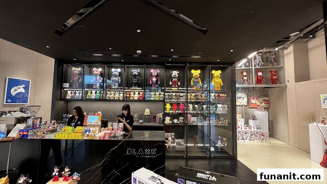Interior view of BLAXK by ActionCity, showcasing collectible figures, merchandise, and a sleek counter.