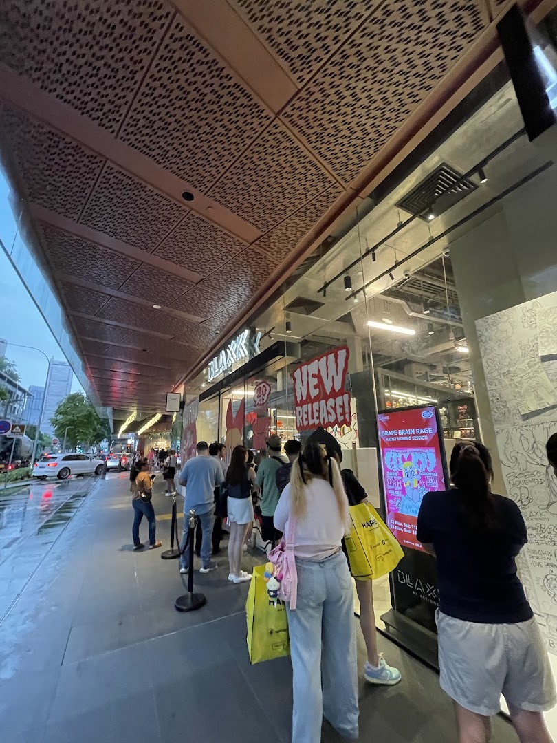 Customers queue outside BLAXK by ActionCity, featuring 'New Release' and 'Grape Brain Rage' event signage.