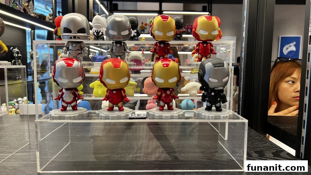 A display of various Iron Man and War Machine collectible figurines inside a retail shop.