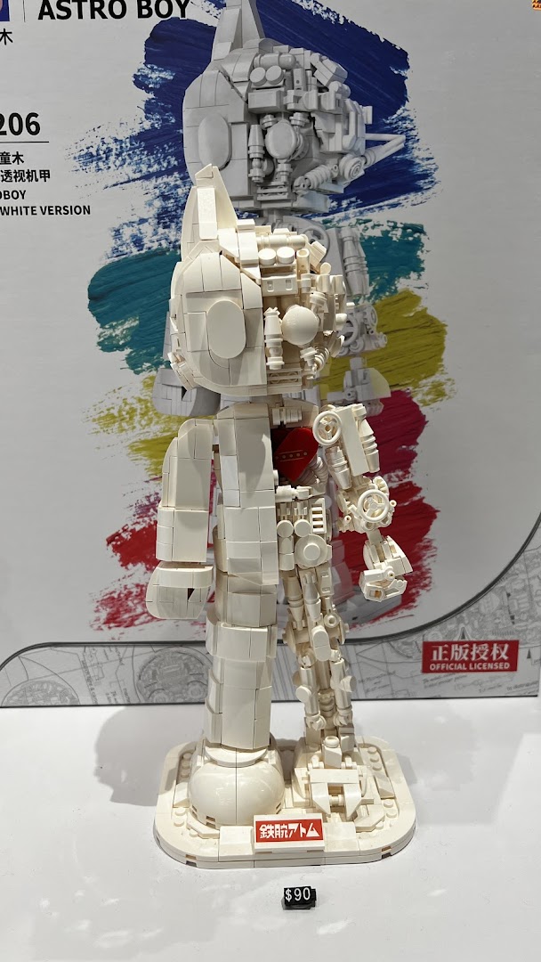 A detailed white buildable Astro Boy figure with exposed internal mechanisms on display.