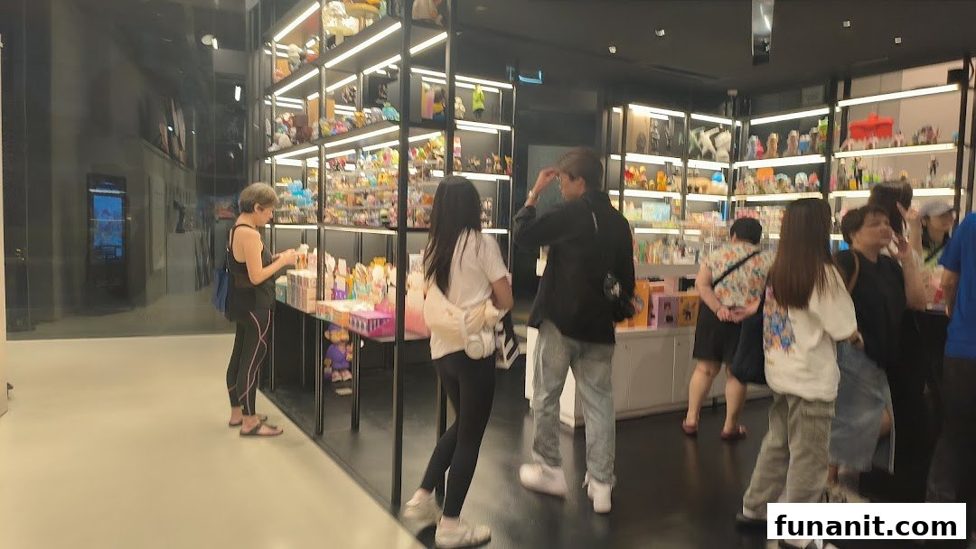 Customers browse a wide array of collectible art toys and figures displayed on brightly lit shelves.
