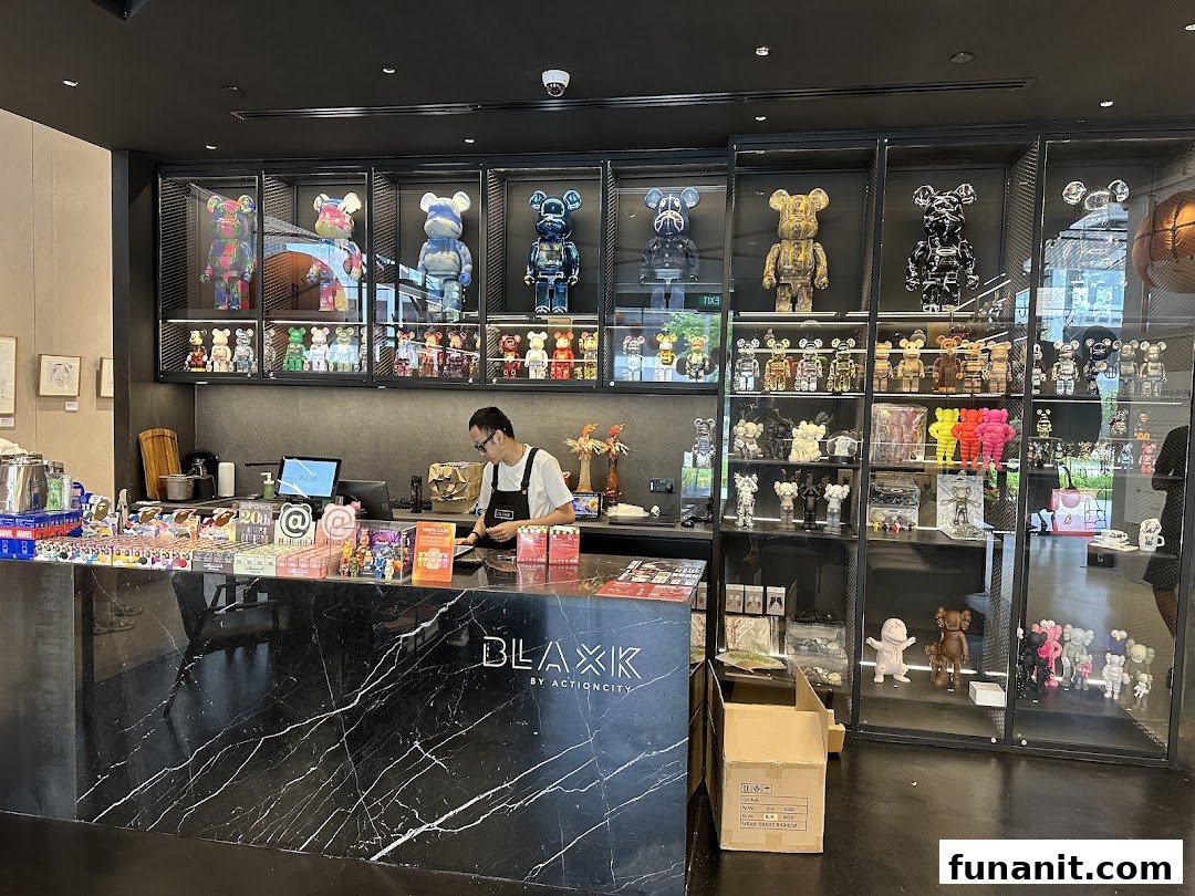 Interior view of BLAXK by ActionCity, featuring a counter, staff, and extensive displays of collectible art toys.