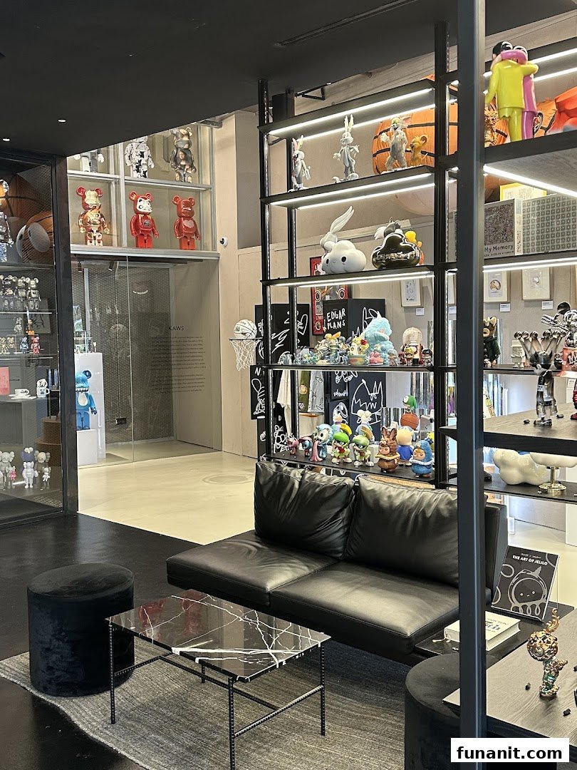 Interior view of BLAXK by ActionCity, showcasing a modern lounge area and shelves filled with unique art toys and collectibles.