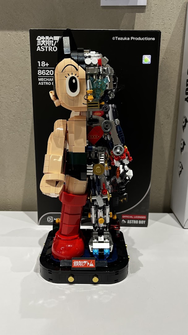 A detailed Astro Boy mechanical model kit displayed with its packaging, showcasing intricate internal components.
