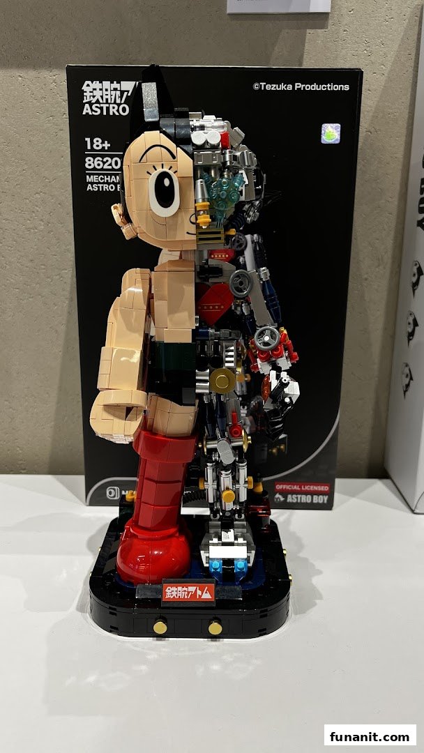 A detailed Astro Boy mechanical model kit displayed with its packaging, showcasing intricate internal components.