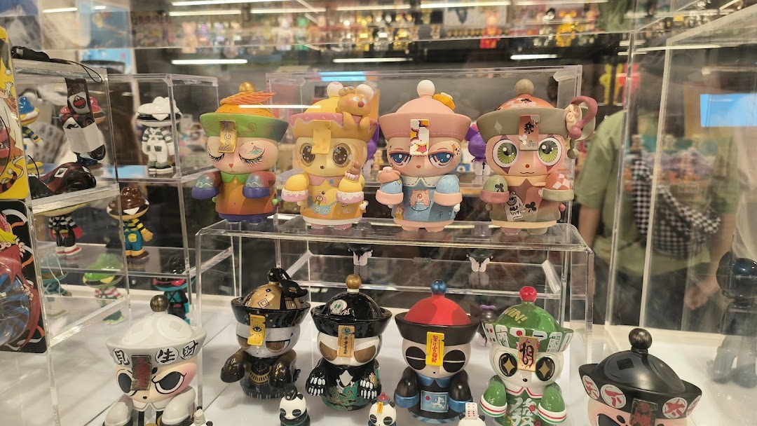 A vibrant display of unique, colorful designer art toys and collectible figurines in a retail shop.