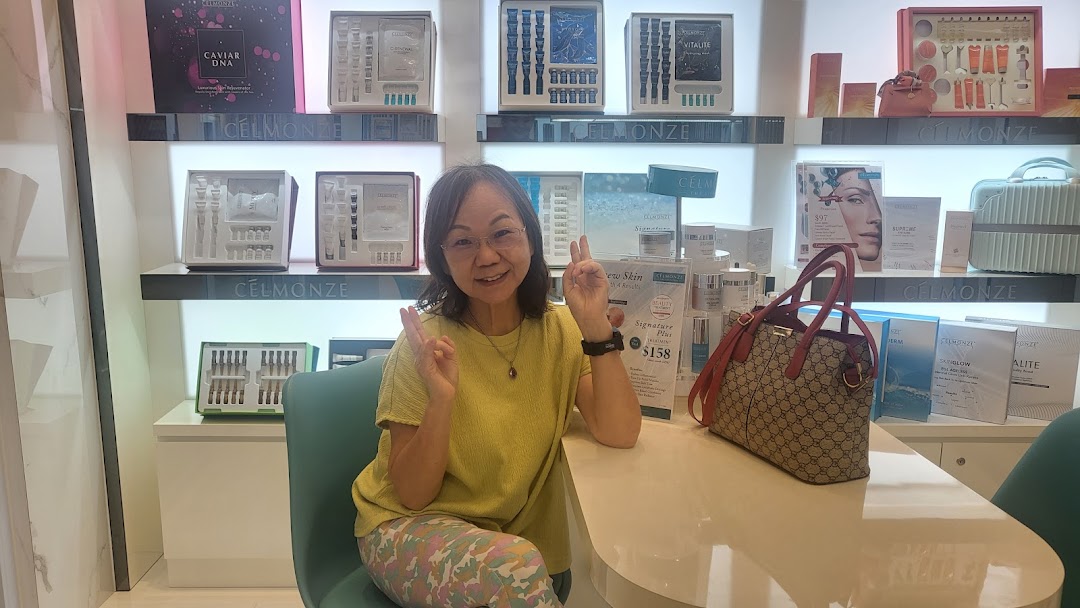 A woman poses happily inside Celmonze Signature Aesthetic Funan, surrounded by skincare products.